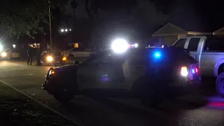 Man shot in foot, fights off robbers holding his family at gunpoint, police say; Neighbor also shot