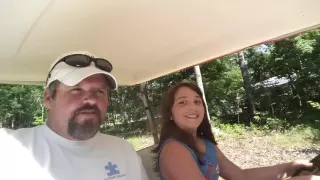 Emily driving a golf cart for the first time.