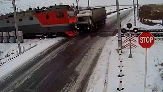 Truck torn apart by two trains at rail crossing in Kazakhstan (VIDEO from surveillance camera)