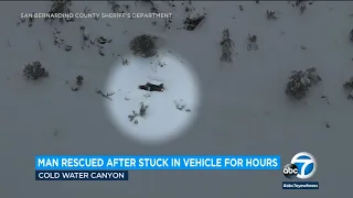 Man rescued after being stuck in snowed in car for hours