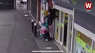 Woman left dangling in mid air after being lifted off her feet by shop shutters