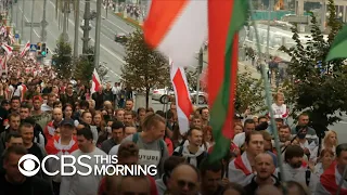 Belarusian President Lukashenko seen toting automatic rifle as mass demonstrations continue