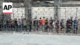 Desperate Palestinians line up for bread in Gaza City amid famine warning