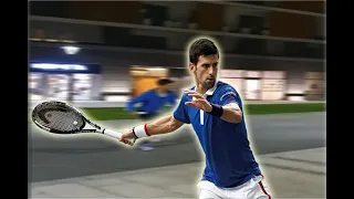 Novak Djokovic playing tennis in front of his building with kids
