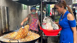 Tables always fully booked! Amazing fried tilapia fish with peanuts crispy garlic | Thai street food
