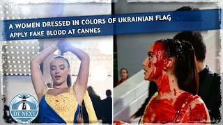 A woman dressed in the colors of  Ukrainian flag paints herself with fake blood at  Cannes | Dt Next