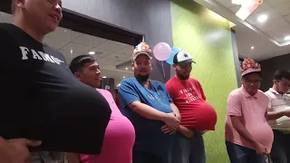 Baby gender reveal game: Preggy men tying their shoes