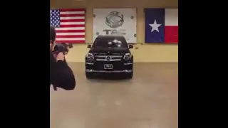 A man sits inside a Mercedes-Benz to take the gun shots in his bullet proof car