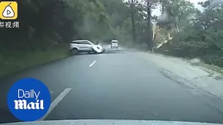 Shocking moment car is smashed by a massive BOULDER