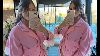 Pregnant Katharine McPhee proudly cradles her baby bump in a pink feathered coat