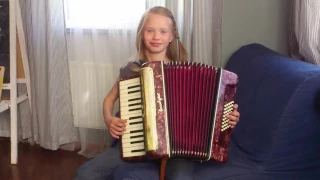 Girl plays the accordion "Vo sadu". Девочка играет на аккордеоне "Во саду ли в огороде".