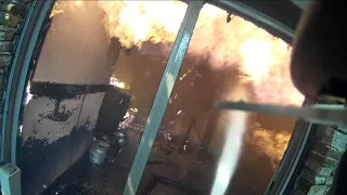 Firefighter helmet cam at a structure fire fully involved.