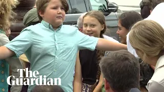 Young boy shields Greta Thunberg from photographers on Capitol Hill