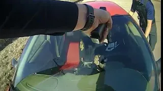 Video shows western Iowa police officer clinging to hood of moving car