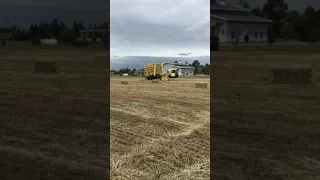 New Holland H9880 stacking small bales of Forage hay.