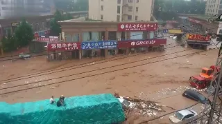 Motorists Seek Refuge On Top Of Truck As Floodwater Rushes Through Chinese City