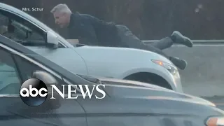 Man clings to the roof of speeding car during road rage incident