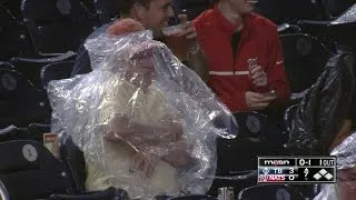 Nats fan struggles to put on rain poncho