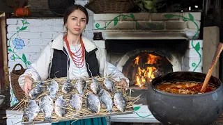 Hard life in village. Woman is cooking traditional Ukrainian food in oven. 300 year old recipes