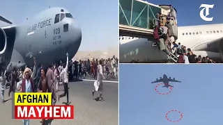 Shocking videos from Kabul airport as hundreds jostle to board plane, 2 fall off plane mid-air