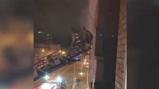 Caught on video: Firefighters rescue family from burning apartment