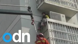 Dramatic rescue of six-year-old girl trapped on ledge in China