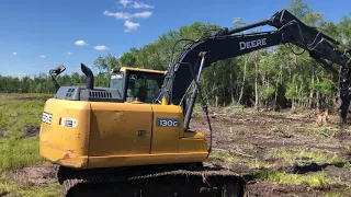 650K and 130G excavator clearing and stumping in North Florida