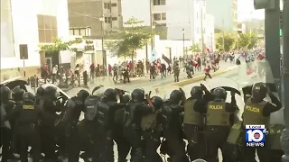 Riot police faces protesters in Peru