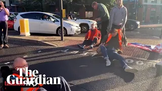 Motorists and paramedic crew drag away Insulate Britain protesters on Wandsworth Bridge