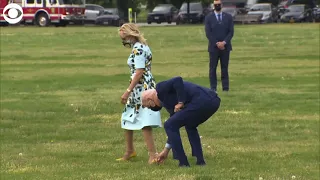 President Joe Biden picks a dandelion for First Lady Jill Biden