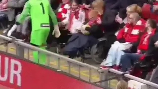 Jerzy Dudek interacts with young disabled lad at legends match.