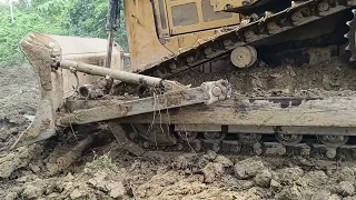 Cat Bulldozer D6R XL's tough job is to pry up rocks while working on road expansion