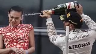 Racing driver Lewis Hamilton soaks Russia's President Vladimir Putin with champagne