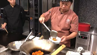 Chef Jian Chit Ming prepares sweet and sour shrimp beignets at 2 Michelin star Canton 8 in Shanghai