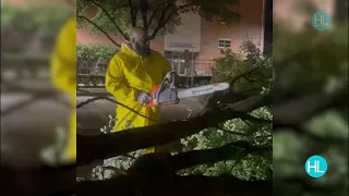 Trae Tha Truth takes on fallen trees with a chainsaw in Downtown Houston