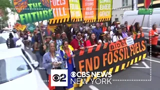 Tens of thousands of anti-fossil fuel protesters march in Midtown