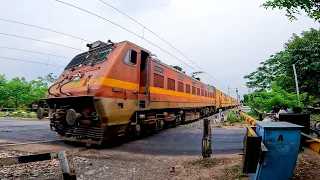 Aerodynamic Wap4 with old livered express train furiously skipping through rail gate