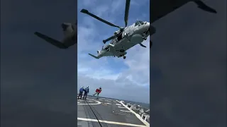 Royal Navy helicopter brings air crewman aboard destroyer USS Paul Ignatius.