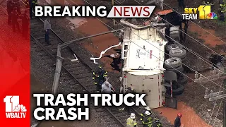 Trash truck falls from bridge in Baltimore crash