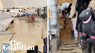 Burning Man festivalgoers surrounded by mud in Nevada desert