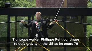 69-year-old tightrope walker Philippe Petit performs at 'Glass House' | AFP