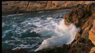 Raging Seas: Powerful Waves Crashing Against Rocky Shores