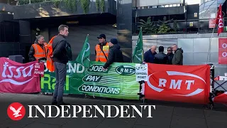 Members of RMT union strike outside Euston station as trains disrupted across UK