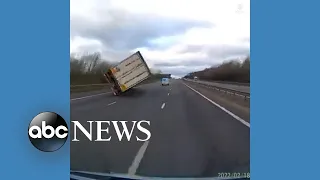 Powerful winds knock over truck on road