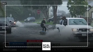 Surfers and kayakers take advantage of flooded streets in Ventura County