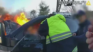 Driver rescued from burning truck by firefighters and police officer