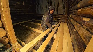 I lay new boards on the floor of the dugout. Rebuilding a house underground in the forest.