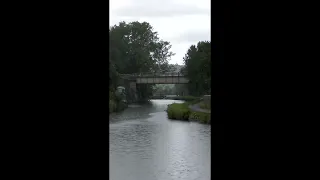 Steam train thrashing over the canal