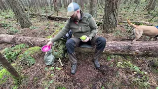 Outdoors in the woods with my dog, cooking a British military ration and drinking tea