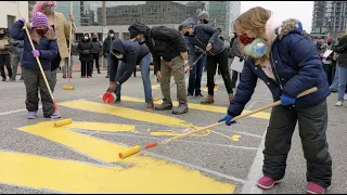 Protesters paint "RESIGN HAWLEY" on street outside Sen. Josh Hawley's St. Louis office